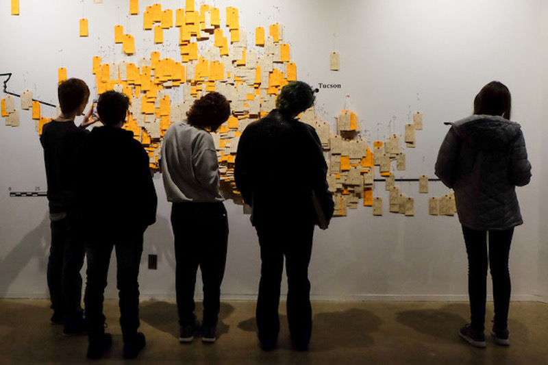 People looking at a board with sticky notes